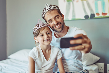 Image showing Man, girl child and selfie in princess tiara, happiness with love and care at family home. Smile in picture, father and daughter bonding with crown, happy people spending time together in bedroom