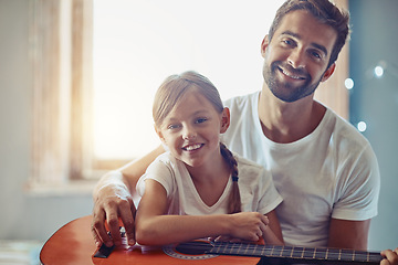Image showing Man, young girl and guitar with teaching and learning at home, bonding with love and creativity in portrait. Family, father and daughter learn to play musical instrument, lesson and music education