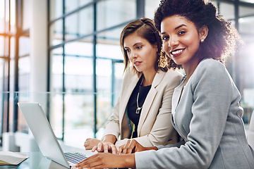 Image showing Business, businesswomen with laptop and at desk in modern office at work. Communication or conversation, portrait of friends or women colleagues and coworkers discussing or speaking in workplace