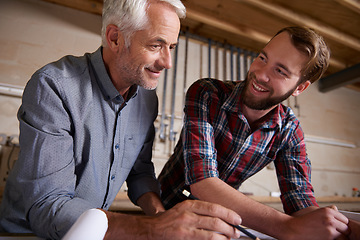 Image showing Architecture, teamwork and man with apprentice in workshop for collaboration. Senior engineer, men and smile with trainee, working on remodeling project and drawing plans on paperwork with mentor.