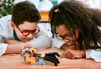 Image showing Engineering, learning and children building a robot hand together in a classroom at school and being curious. Clever, education and young engineer students working in a science class doing research