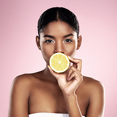 Image showing Portrait, woman and lemon for beauty in studio, pink background and wellness of vitamin c cosmetics. Face of african model, citrus fruits and nutrition for skincare, organic benefits and natural diet