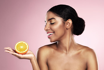 Image showing Happy woman, orange fruit and beauty in studio, pink background or wellness of healthy vitamin c cosmetics. African model, citrus and nutrition for natural facial skincare, organic benefits or mockup