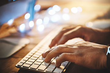 Image showing Hands, keyboard and closeup of man typing while doing research on a computer in the office at night. Professional, technology and male employee working overtime on a deadline project in the workplace