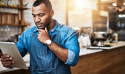 Image showing Focus, tablet and thinking with man in cafe for online, entrepreneurship and startup. Retail, technology and food industry with small business owner in restaurant for barista, store and coffee shop