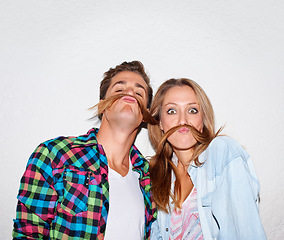 Image showing Portrait, funny and couple with moustache hair, silly and happiness isolated against a grey studio background. Face, man and woman with facial expression, goofy or partners with joy, bonding and love