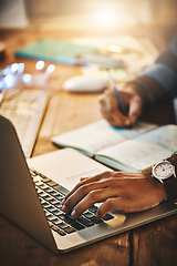 Image showing Hand, typing and man on a laptop while writing research notes for creative project at night. Planning, professional and closeup of male employee working overtime with computer and notebook in office.