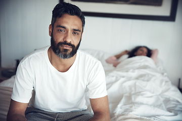 Image showing Sad, depression and portrait of a man on a bed with wife sleeping in the morning. Upset, depressed and a mature male person looking tired, frustrated or unhappy with a woman in the bedroom for sleep