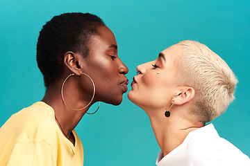 Image showing Love, diversity and kiss, lesbian couple on studio background in happy lgbt relationship together. Lgbtq romance, pride and black woman kissing partner on backdrop, happiness with gen z women on date