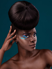 Image showing Portrait, beauty and hair with an african woman in studio on a blue background for makeup or cosmetics. Face, haircare and fashion with an attractive young female model at the salon for trendy style