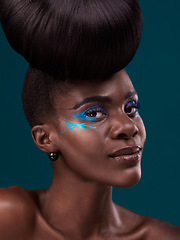 Image showing Portrait, haircare and makeup with a model black woman in studio on a blue background for beauty. Face, hair and cosmetics with an attractive young female person at the salon for fashion or styling