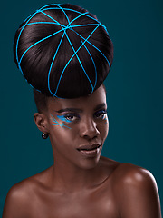 Image showing Portrait, hair and fashion with a model black woman in studio on a blue background for beauty. Face, haircare and cosmetics with an attractive young female person at the salon for makeup or styling