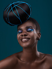 Image showing Happy, hair and makeup with a model black woman in studio on a blue background for beauty. Smile, haircare and cosmetics with an attractive young female person at the salon for fashion or styling