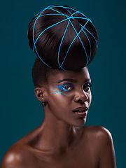 Image showing Portrait, fashion and hair care with a model black woman in studio on a blue background for beauty. Face, beauty and cosmetics with an attractive young female person at a salon for contemporary style
