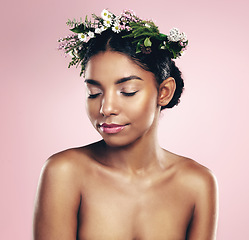 Image showing Woman, flowers and crown for beauty in studio, pink background and natural skincare. African face, female model and floral headband of spring plants, sustainable cosmetics and eco friendly makeup