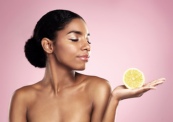 Image showing Lemon, natural beauty and woman in studio, pink background and mockup of nutrition. African model, healthy skincare and citrus fruit of sustainable cosmetics, vegan dermatology and vitamin c benefits