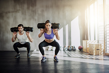 Image showing Fitness, health and strong with people lifting weighted bags in the gym during a workout for physical power. Exercise, weightlifting or sports with a man and woman bodybuilder training for wellness