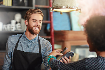 Image showing Man, barista and client with smartphone payment, cafe and transaction for services, smile and fintech. Female customer, male employee and happy guy at a coffee shop, small business and financial