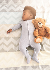 Image showing Top view, bed and baby sleeping with teddy bear for rest, nap time and dreaming in nursery. Childcare, newborn and cute, tired and African child in bedroom sleep for comfort, relax and calm at home