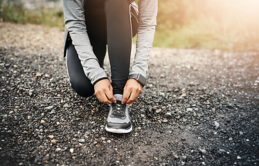 Image showing Closeup, fitness and woman outdoor, tie shoes and cardio workout for training, run and exercise. Zoom, female person or athlete start with practice, hands and runner outside for a marathon and sports