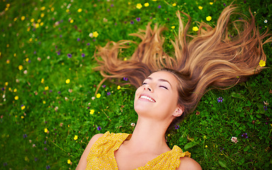 Image showing Top view, relax or woman on grass, flowers or freedom with happiness, care or healthy. Female person, natural or happy lady with a smile, carefree or wellness outdoor, nature or spring time with hair