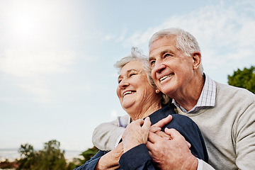 Image showing Sky, elderly couple and hug outdoors or happy in retirement or husband and wife in nature. Mature, man and woman smile in vacation or senior citizens care and embrace or date at the park for romance