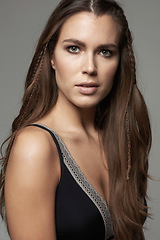 Image showing Woman, face and portrait in natural beauty of model posing with long hairstyle or makeup against a grey studio background. Isolated young and confident female person with facial cosmetics on backdrop