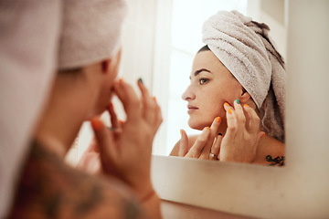 Image showing Beauty, acne and woman cleaning her face for skincare morning routine in her bathroom in a home or house. Facial, pimple and female person doing cosmetic self love or care in her house mirror