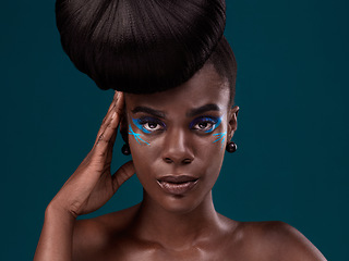 Image showing Portrait, hair and makeup with a model black woman in studio on a blue background for beauty. Face, haircare and cosmetics with an attractive young female person at the salon for fashion or styling