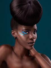 Image showing Portrait, cosmetics and hair care with an african woman in studio on a blue background for beauty or makeup. Eyeshadow, hairstyle and fashion with an attractive young female model at the salon