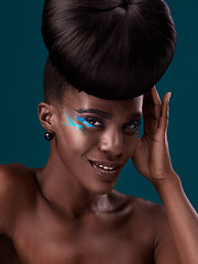 Image showing Portrait, makeup and happy with an african woman in studio on a blue background for hair or cosmetics. Eyeshadow, smile and fashion with an attractive young female model at the salon for style