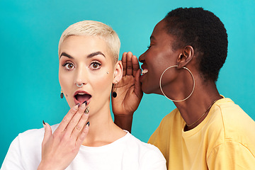 Image showing Surprise secret, shock and girl friends portrait with privacy, laugh and gossip in a studio. Blue background, women and smile of a female person with whisper and news telling a story and listening