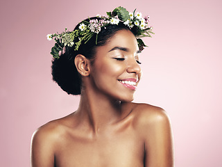 Image showing Happy woman, flower crown in hair for beauty in studio, pink background and natural skincare. African face, female model and floral headband of plants, sustainable cosmetics and eco friendly fashion
