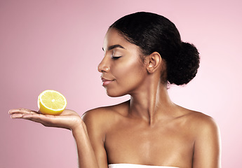 Image showing Lemon fruit, beauty and woman in studio, pink background and mockup of healthy nutrition. African model, natural skincare and citrus of sustainable cosmetics, vegan dermatology and vitamin c benefits