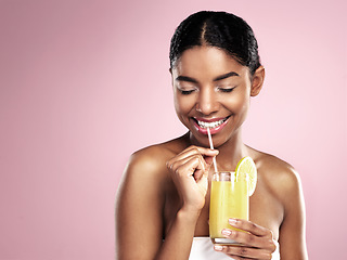 Image showing Happy woman drink glass of orange juice in studio, pink background and mockup for healthy skincare. African model, fruit cocktail and smoothie for nutrition benefits, natural beauty or vitamin c diet