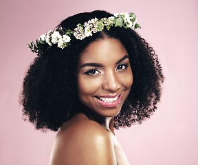 Image showing Happy woman, portrait and flower crown for beauty in studio, pink background and natural skincare. Face of african model, floral wreath and plants for sustainable cosmetics, hair care and dermatology