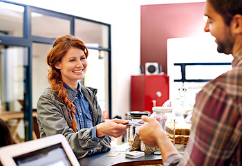 Image showing Woman, customer and credit card at a coffee shop for payment with a smile at restaurant. Female person, happiness and machine scan to pay and buy at a cafe with male store assistant and barista