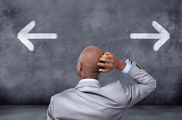 Image showing Business, chalkboard and black man with a decision, arrows and choices for career development, opportunity and confusion. Male employee, consultant or entrepreneur with symbol and icons for direction