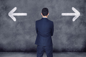 Image showing Back, business and man with decision, opportunity and choice with startup, arrows and chalkboard. Male person, employee and entrepreneur with ideas, confused and consultant with formal wear or a suit