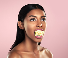 Image showing Detox, fruit and woman with apple in her mouth for beauty empowerment isolated in a studio pink background. Skincare, food and female model or person on diet for self love or cosmetic care