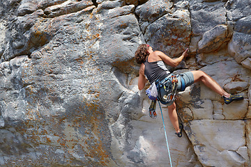 Image showing Rock climbing, fitness and travel with woman on mountain for adventure, challenge and explore. Strong, freedom and hiking with female climber training in nature for courage, safety and workout