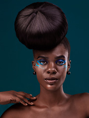Image showing Portrait, hair and makeup with an african woman in studio on a blue background for beauty or cosmetics. Face, haircare and fashion with an attractive young female model at the salon for trendy style