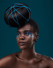 Image showing Idea, hair care and makeup with a model black woman in studio on a blue background for beauty. Thinking, fashion and cosmetics with an attractive young female person at the salon for a hairstyle