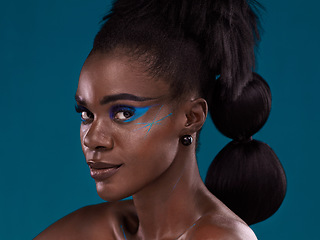 Image showing Portrait, hair and makeup with an african woman in studio on a blue background for beauty or cosmetics. Face, haircare and fashion with an attractive young female model posing for natural style