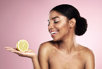 Image showing Lemon, healthy beauty and happy woman in studio mockup, pink background and smile for vitamin c benefits. African model, citrus fruits and natural skincare for cosmetics, vegan dermatology and detox