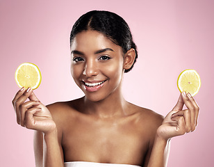 Image showing Portrait of happy woman, lemon and skincare in studio, pink background or wellness of vitamin c benefits. Face of african model, citrus fruits and nutrition of beauty, organic cosmetics or detox diet