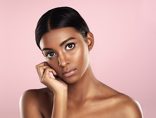 Image showing Face portrait, skincare and serious woman in studio isolated on a pink background. Natural beauty, aesthetic and Indian female model with makeup, cosmetics or spa facial treatment for healthy skin.