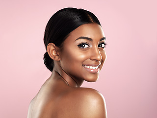 Image showing Face, skincare and smile of woman in studio isolated on a pink background mockup space. Natural beauty, portrait and Indian female model with makeup, cosmetics or spa facial treatment for skin health