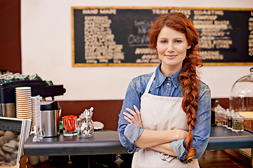 Image showing Portrait, woman and barista with arms crossed, cafe and happiness with startup success, business and growth. Face, female employee and happy entrepreneur in a coffee shop, restaurant and development