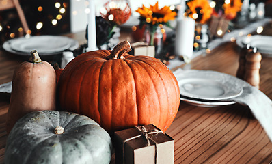 Image showing Thanksgiving, pumpkin and holiday celebration or table in a empty home dining room with decoration. Season, art and creative background with orange vegetable, place setting and rustic inspiration